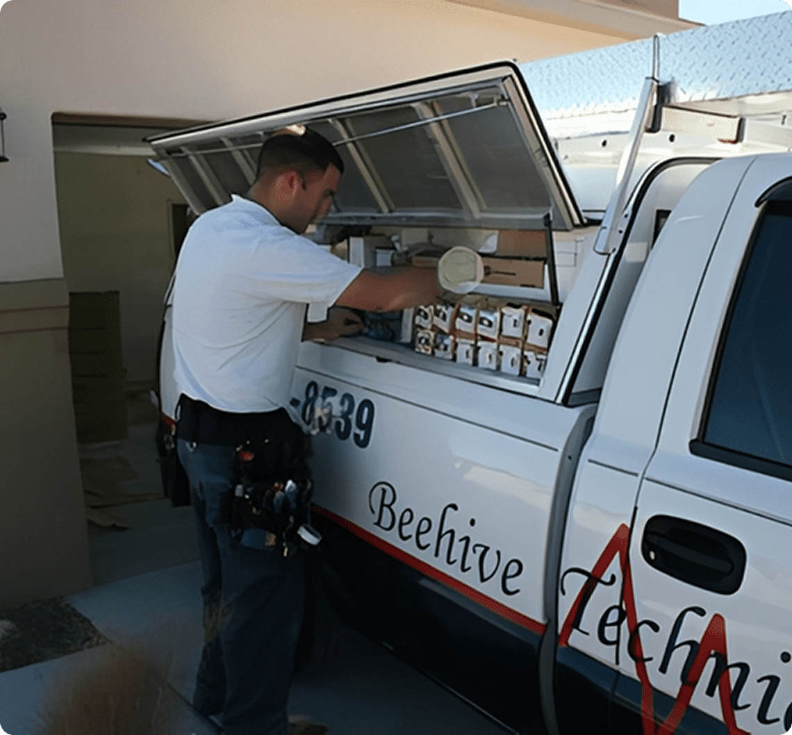 Worker accessing tools in vehicle compartment